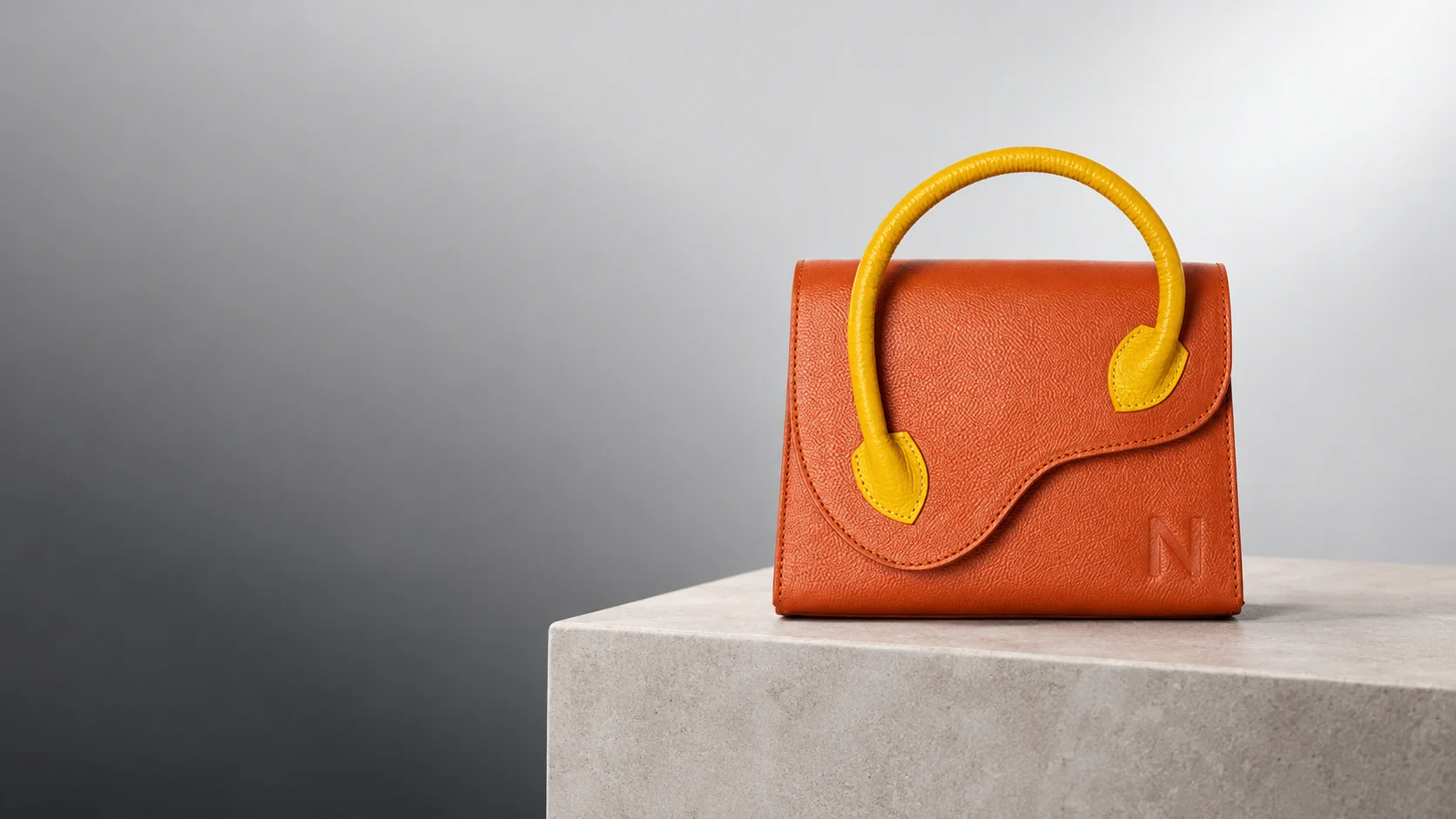Nirvana orange Multi Diva clutch with a sculptural yellow handle